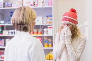 Costumer blowing in front of pharmacist
