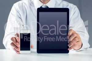 Businessman showing smartphone and tablet
