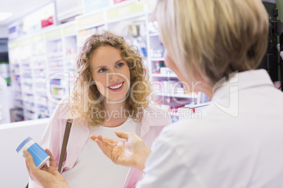 Pharmacist and her customer talking about medication
