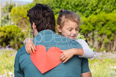 Daughter giving dad a heart card