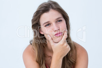 Curious woman with hand on jaw