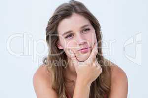 Curious woman with hand on jaw