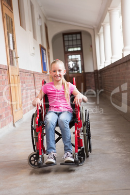 Cute disabled pupil smiling at camera in hall Cute disabled pupil smiling at camera in hall