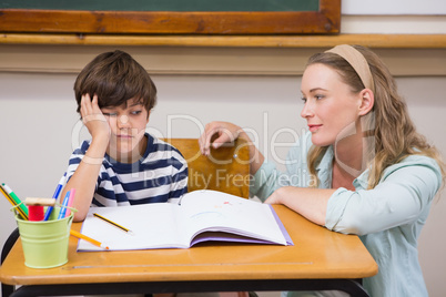 Teacher helping pupil