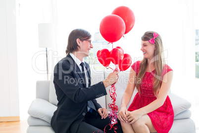 Cute geeky couple with red balloons