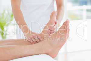 Physiotherapist doing foot massage