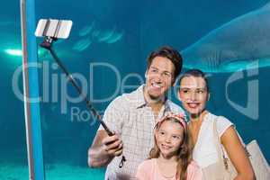 Happy family using selfie stick