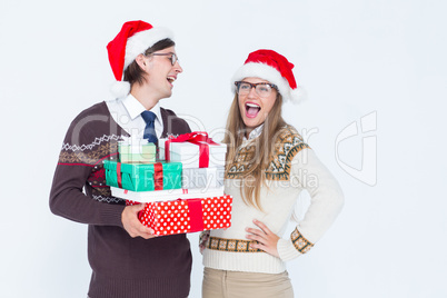 Geeky hipster couple holding presents