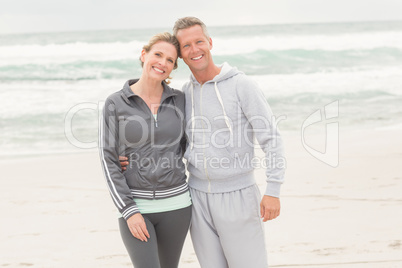 Fit couple smiling at camera