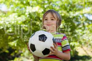 Happy little boy holding football