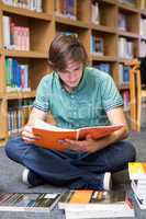 Student sitting on floor in library