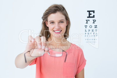 Hipster showing glasses next to an eye test