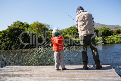 Happy man fishing with his son