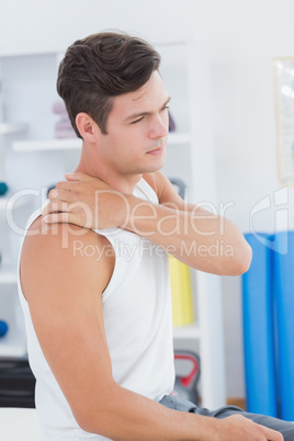Young man suffering from shoulder pain