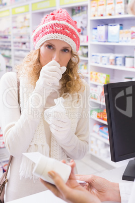 Sick girl with scarf and colorful hat looking at camera