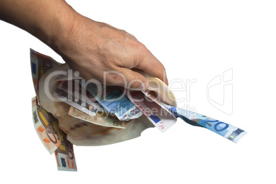 a hand is holding a sea shell with money white background.