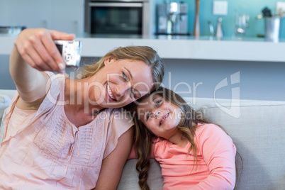 Happy mother and daughter on the couch