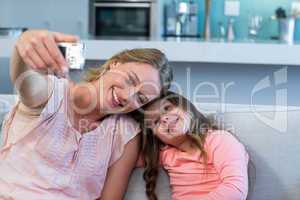 Happy mother and daughter on the couch