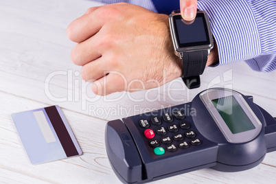Man using smart watch to express pay