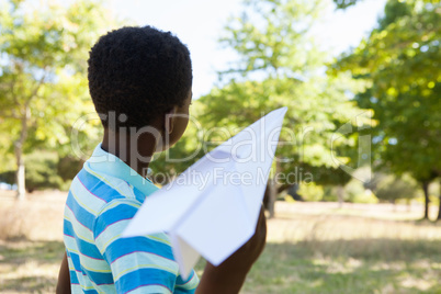 Cute little boy with paper airplane