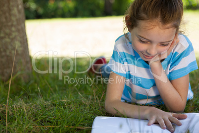 Cute little girl reading in park