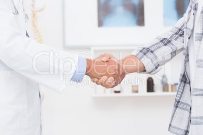 Patient shaking hands with doctor