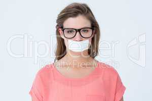 Geeky hipster with adhesive tape on mouth