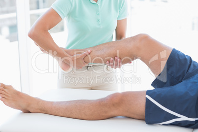 Doctor examining man leg