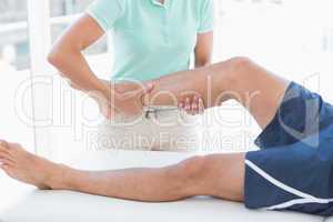 Doctor examining man leg