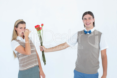 Geeky hipster offering red roses to his girlfriend