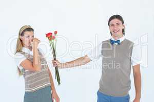Geeky hipster offering red roses to his girlfriend