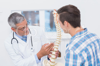 Doctor showing anatomical spine to his patient