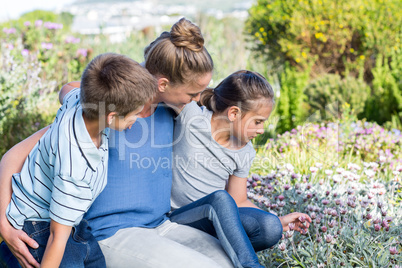 Mother and children tending to flowers