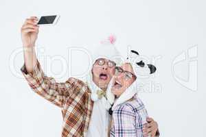 Geeky hipster couple taking selfie with smart phone