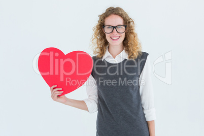 Geeky hipster holding heart card Geeky hipster holding heart card