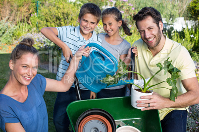 Happy young family gardening together