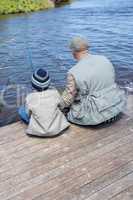 Father and son fishing at a lake