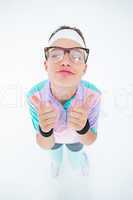Smiling geeky hipster looking at camera thumbs up