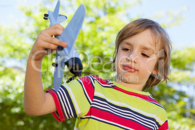 Happy little boy with toy airplane