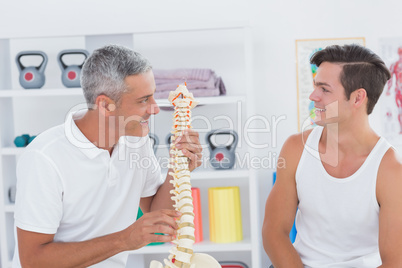 Doctor showing anatomical spine to his patient