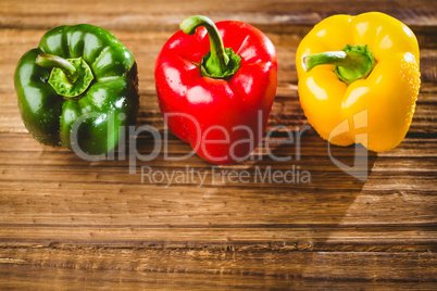 Three peppers on chopping board Three peppers on chopping board
