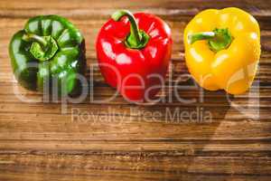 Three peppers on chopping board