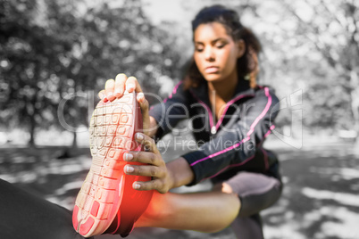 Highlighted ankle of stretching woman