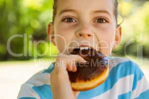 Cute little girl eating doughnut