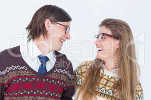 Happy geeky hipster couple looking at each other