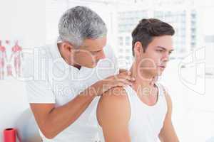 Doctor examining his patient neck