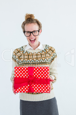 Excited geeky hipster holding present