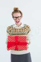 Excited geeky hipster holding present