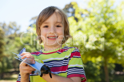 Happy little boy with toy airplane