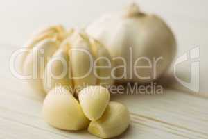 Garlic cloves and bulb on chopping board